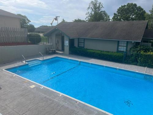 a large blue swimming pool in front of a house at The Greens at Thousand Hills in Branson