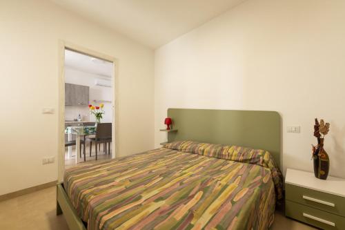 a bedroom with a bed and a dining room at Centonze appartamenti in San Foca