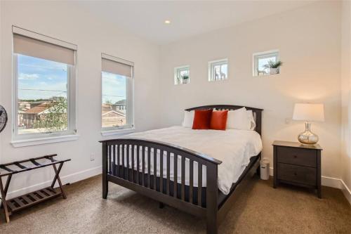 a bedroom with a crib and two windows at With Pool Table Near to RiNo and City Park in Denver