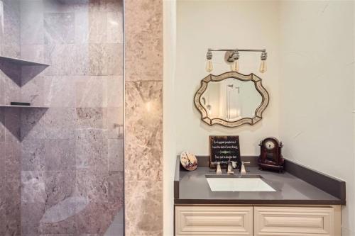 a bathroom with a sink and a mirror at With Pool Table Near to RiNo and City Park in Denver