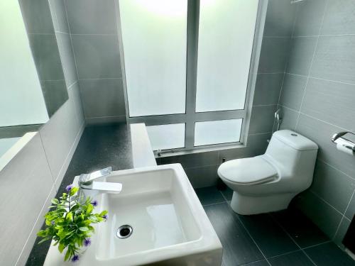 a bathroom with a white sink and a toilet at KSL City Mall 6-20pax Private Lift-Netflix-SmartTV 70inch in Johor Bahru