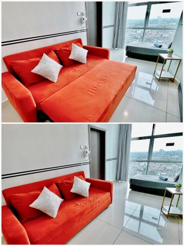 a red couch in a room with a large window at KSL City Mall 6-20pax Private Lift-Netflix-SmartTV 70inch in Johor Bahru