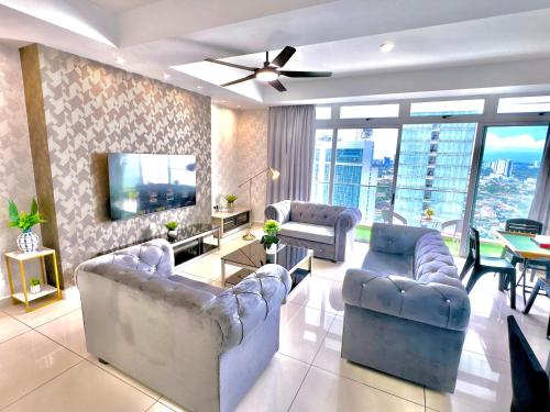 a living room with two couches and a tv at KSL City Mall 6-20pax Private Lift-Netflix-SmartTV 70inch in Johor Bahru
