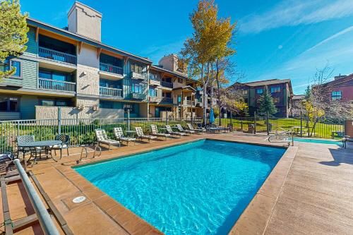 a swimming pool in front of a apartment building at Phoenix 229 in Steamboat Springs