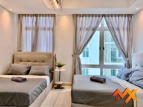 two beds in a room with a window at KSL City Mall 6-20pax Private Lift-Netflix-SmartTV 70inch in Johor Bahru