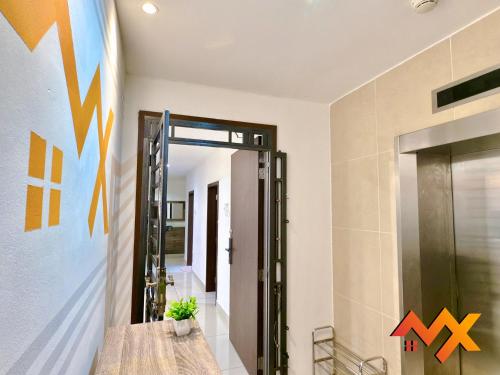 a hallway with a mirror and a door with arrows on the wall at KSL City Mall 6-20pax Private Lift-Netflix-SmartTV 70inch in Johor Bahru