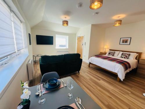 a living room with a bed and a couch at Viewforth Studio No.3 in Fort William