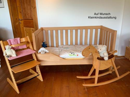 a wooden bed with a wooden horse and a chair at Panoramachalet Tirolernaturschlaf in Wildschönau