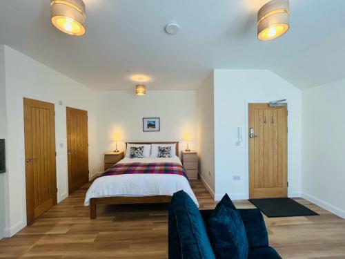 a bedroom with a bed and a couch at Viewforth Studio No.4 in Fort William