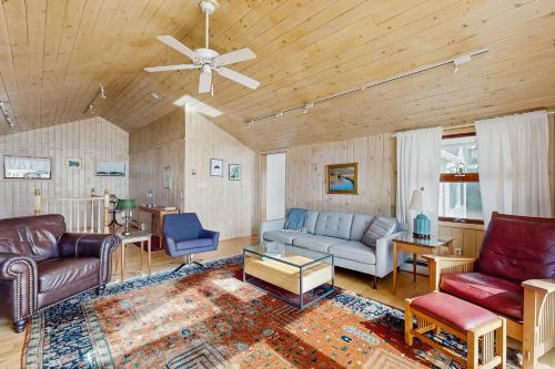 a living room with couches and a ceiling fan at By the Sea in South Freeport