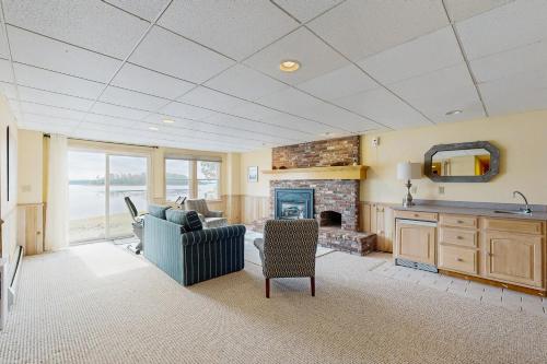 a living room with a couch and a fireplace at By the Sea in South Freeport