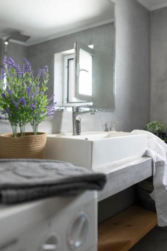 a bathroom with a white sink and a mirror at Ethos Retreat, Luxury Villas in Areopolis