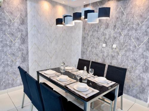 a dining room with a table and blue chairs at KSL City Mall 6-20pax Private Lift-Netflix-SmartTV 70inch in Johor Bahru