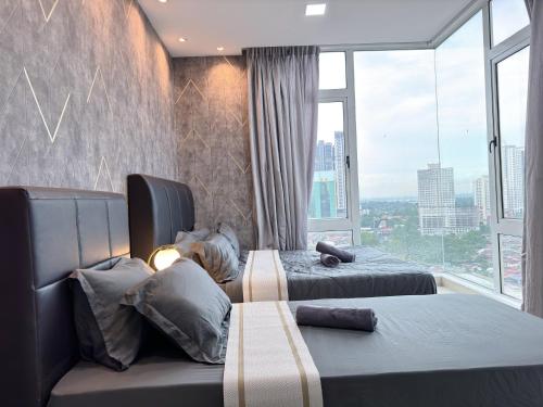 a hotel room with two beds and a large window at KSL City Mall 6-20pax Private Lift-Netflix-SmartTV 70inch in Johor Bahru