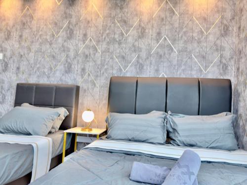 two beds sitting next to each other in a bedroom at KSL City Mall 6-20pax Private Lift-Netflix-SmartTV 70inch in Johor Bahru