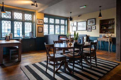 a dining room with a table and chairs at The Mayflower in Lymington