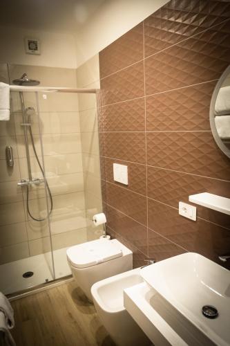 a bathroom with a shower and a toilet and a sink at Chez Nunù in Ercolano