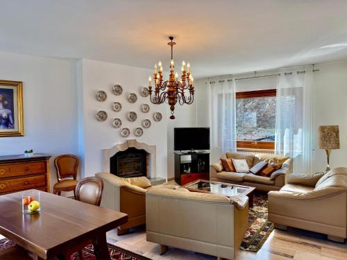 a living room with a chandelier and a fireplace at Villetta Rosa in Domodossola