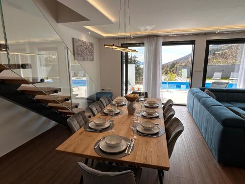 a living room with a wooden table and a blue couch at Villa Agata in Lovran