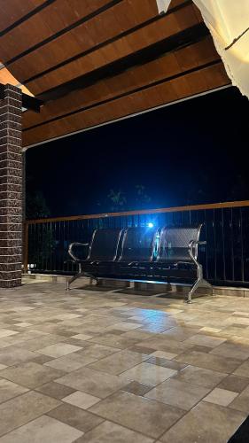 a bench sitting on a patio at night at Wayanad Haven Villa in Wayanad