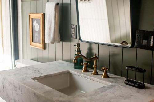 a bathroom with a white sink and a mirror at A-frame 10 Min to Downtown Durango in Durango