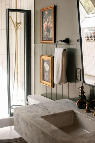 a bathroom with a sink and a toilet and a mirror at A-frame 10 Min to Downtown Durango in Durango