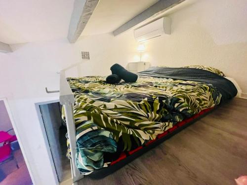 - un lit dans une petite chambre avec un lit sidx sidx sidx dans l'établissement 4 Soleil - Mezzanine Wifi Clim Plage Parking, au Cap d'Agde
