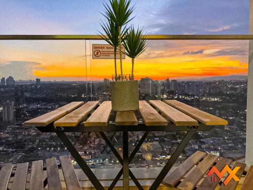 a wooden table with a potted plant on top of a city at KSL City Mall 6-20pax Private Lift-Netflix-SmartTV 70inch in Johor Bahru