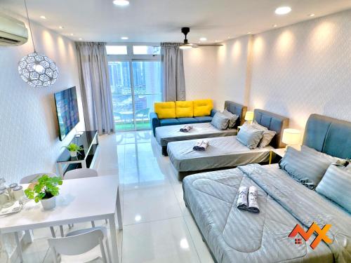a living room with two beds and a couch at KSL City Mall 6-20pax Private Lift-Netflix-SmartTV 70inch in Johor Bahru