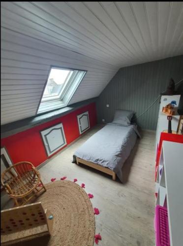 une chambre mansardée avec un lit et une fenêtre dans l'établissement Maison 12 pers avec piscine 