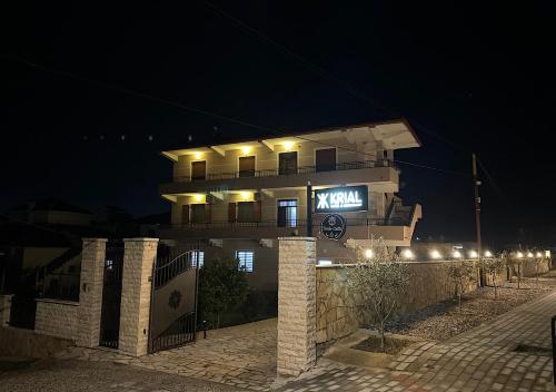 a building with a sign on it at night at Hotel Krial in Berat