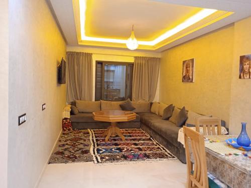 a living room with a couch and a table at 1 min de la plage in Essaouira