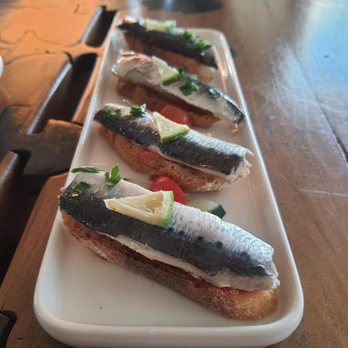 three hot dogs on a plate on a table at Casa Taos in Marrakech