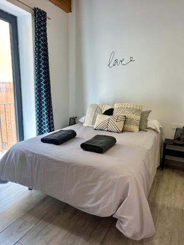 a large bed in a room with a large window at H&H Suite Love Alhambra in Granada