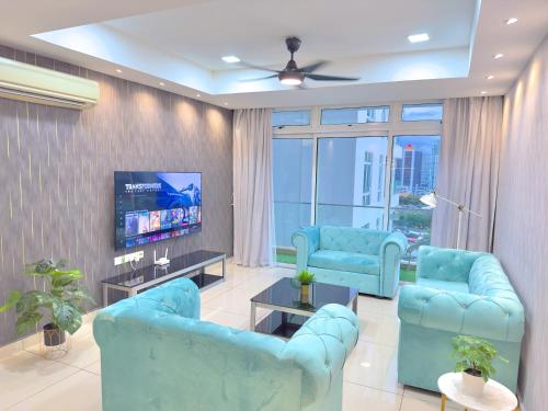 a living room with blue chairs and a flat screen tv at KSL City Mall 6-20pax Private Lift-Netflix-SmartTV 70inch in Johor Bahru