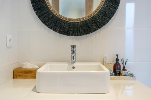 a bathroom with a white sink and a mirror at La Palma - Sleek, Stylish & Spacious - Brand New 2-Bedroom Villa with Large Pool in Canggu! in Canggu