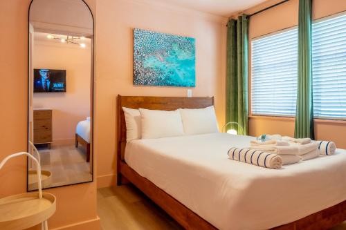a bedroom with a bed and a mirror at Monaco Vacation Rentals in Clearwater Beach