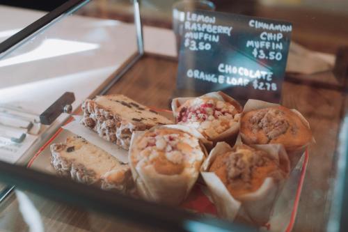 a display case with a bunch of different types of pastries at Talbot Commons Hotel in Taylor
