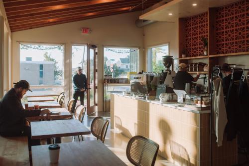 a group of people sitting at tables in a restaurant at Talbot Commons Hotel in Taylor