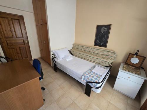 a small room with a small bed and a desk at Booklou Apartment in Ancient Epidavros