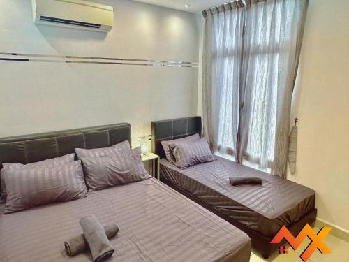 two beds in a room with a window and twox at KSL City Mall 6-20pax Private Lift-Netflix-SmartTV 70inch in Johor Bahru