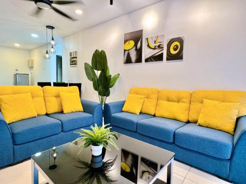 a living room with a blue couch and yellow pillows at KSL City Mall 6-20pax Private Lift-Netflix-SmartTV 70inch in Johor Bahru