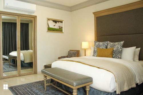 a bedroom with a large bed with a large headboard at Azul Talavera Country Club in Torreón