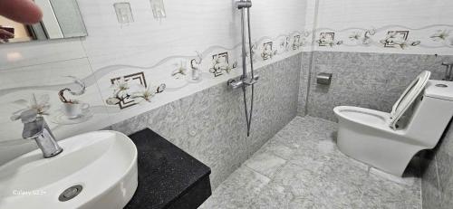 a bathroom with a sink and a toilet in it at Chi's House in Hue