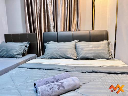 two beds sitting next to each other in a room at KSL City Mall 6-20pax Private Lift-Netflix-SmartTV 70inch in Johor Bahru