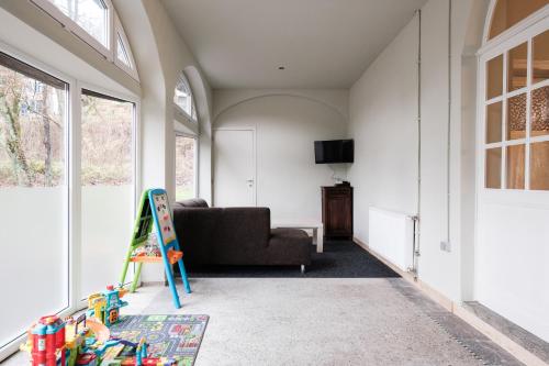 a living room with a couch and a table at Maison Meuse in Waulsort