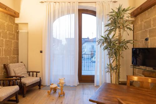 a living room with a table and a large window at Hotel Ristorante Da Politano in Boves