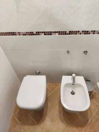 a bathroom with a toilet and a sink at LakeView Loft - Lago di Bolsena in Capodimonte