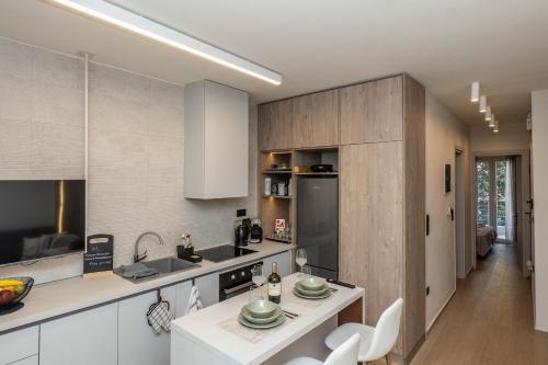 a kitchen with white cabinets and a counter top at 8 Blocks Apartments in Alexandroupoli