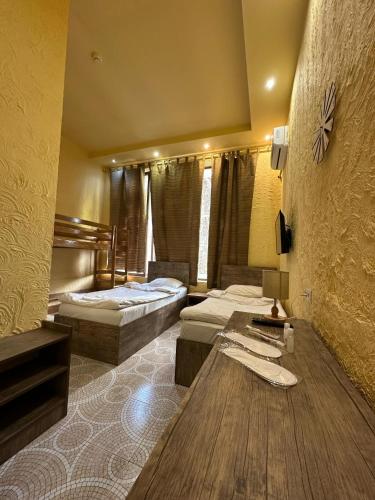 a hotel room with two beds and a table at Li-Yes Qanaqer in Yerevan